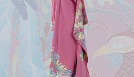a pink kimono with design on the bottom and sleeves