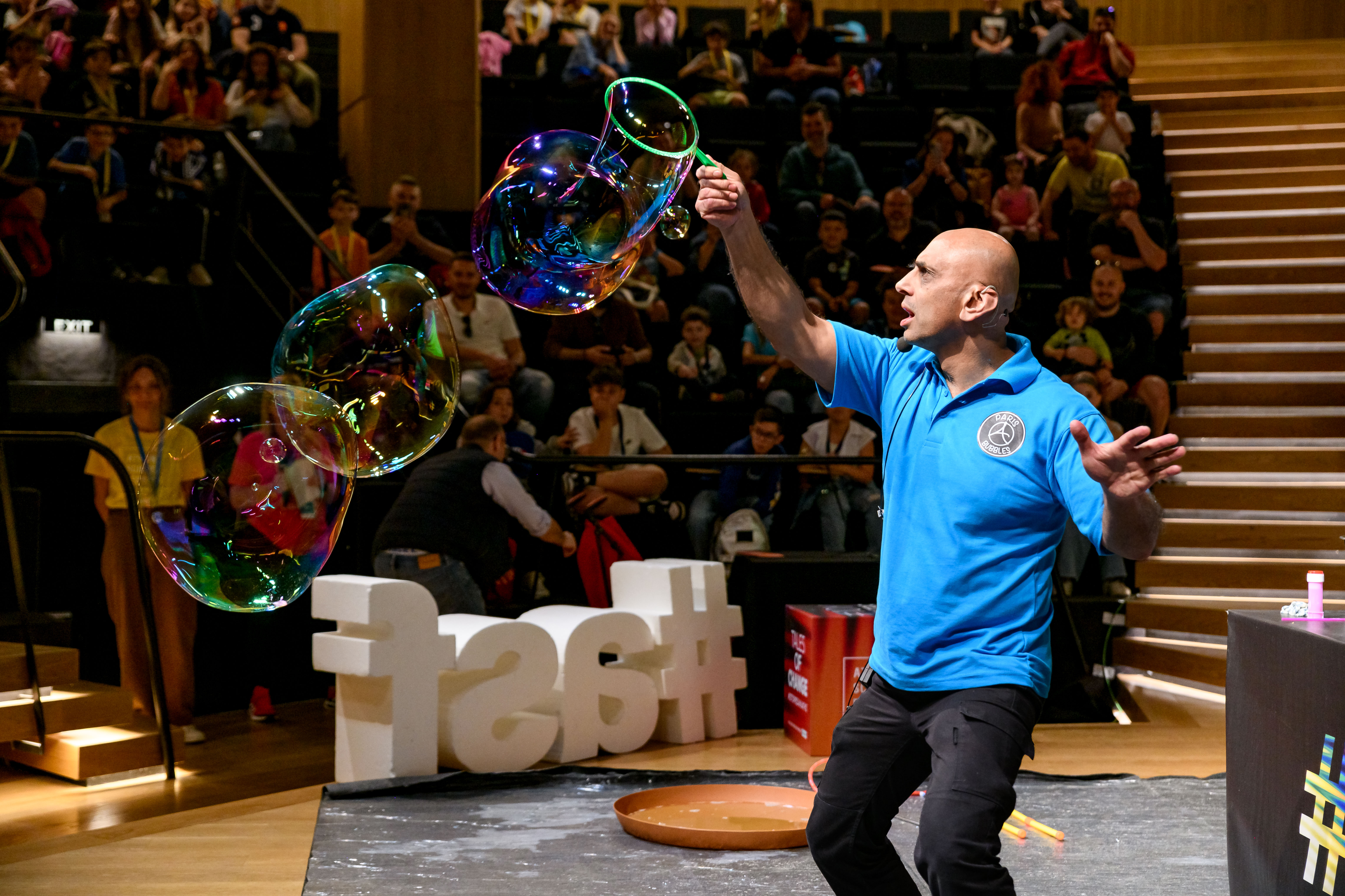 man in blue polo shirt creating bubbles